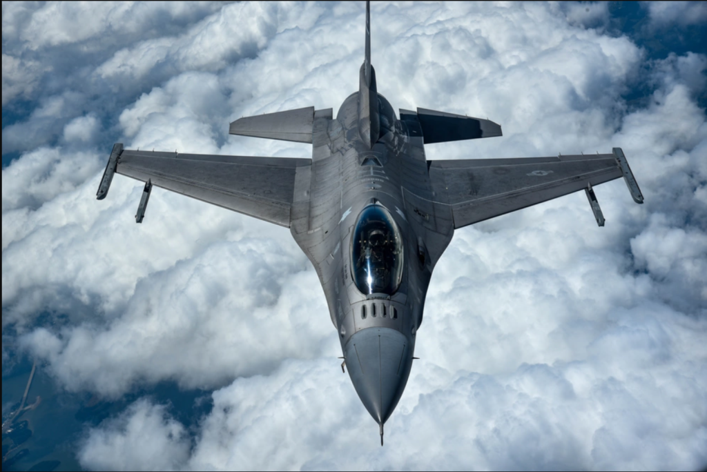 F-16 jet flying in clouds